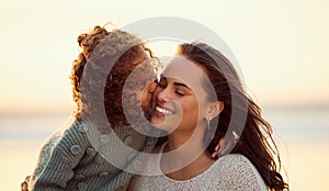 Loving mixed race mother at the beach with adorable little daughter. Mom and child enjoying beach day during summer