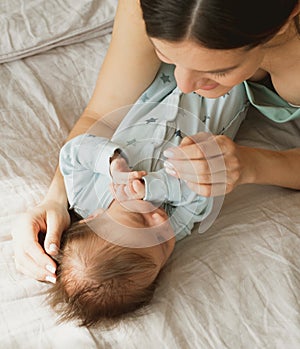 Loving mom carying of her newborn baby at home.