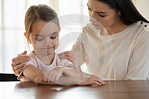 Loving mom comfort sad little daughter after fight