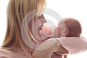 Loving mom holds her newborn baby in her arms, cute tiny baby. Portrait a Mom and her baby. The concept of a happy family