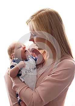 Loving mom holds her newborn baby in her arms, cute tiny baby. Portrait a Mom and her baby. The concept of a happy family