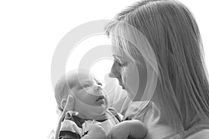 Loving mom holds her newborn baby in her arms, cute tiny baby. Portrait a Mom and her baby. The concept of a happy family.