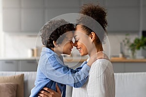 Loving moment as black mother and son share tender forehead touch