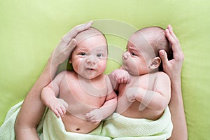 Loving mother hands embrace twins babies