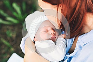 Loving mother with her newborn baby on her arms.