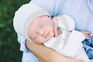 Loving mother with her newborn baby on her arms.