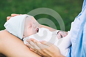 Loving mother with her newborn baby on her arms.