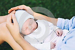 Loving mother with her newborn baby on her arms.