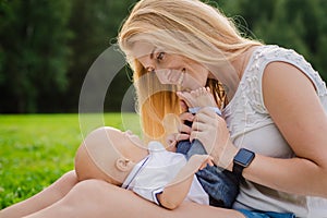 Loving mother with her newborn baby on her arms.