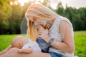 Loving mother with her newborn baby on her arms.