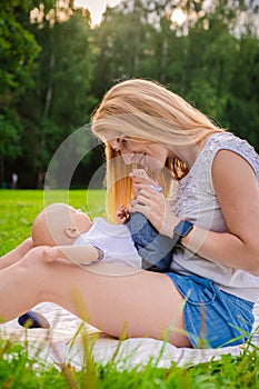 Loving mother with her newborn baby on her arms.