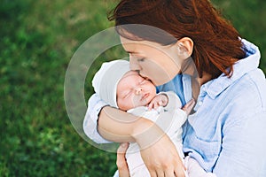 Loving mother with her newborn baby on her arms.