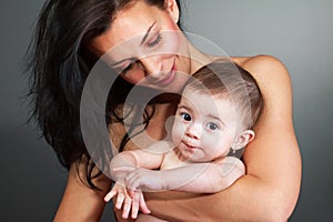 Loving mother holding baby - studio shot