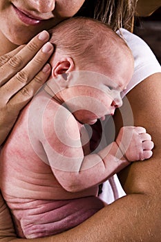 Loving mother holding newborn baby