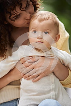 loving mother hugging and kissing head