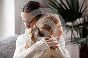 Loving mother hugging little girl, moms love and adoption concep