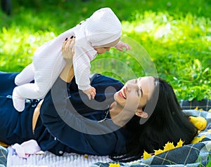 Loving mother laughing as she plays with her baby.
