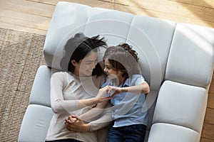 Loving mother and son join their fingers showing heart shape