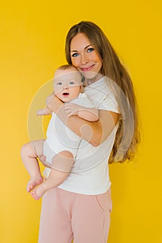 Loving mother takes care of a newborn baby at home. portrait of a happy mother holding a sweet son in her arms