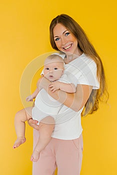 Loving mother takes care of a newborn baby at home. portrait of a happy mother holding a sweet son in her arms