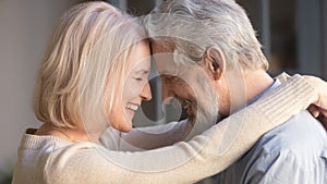 Loving old family couple bonding embracing enjoying moment of affection photo