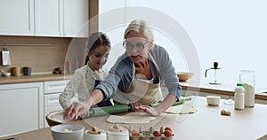 Loving older 60s granny teach her preschooler grandchild to cook