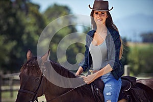 Loving the outdoors. Portrait of a gorgeous cowgirl with her horse.