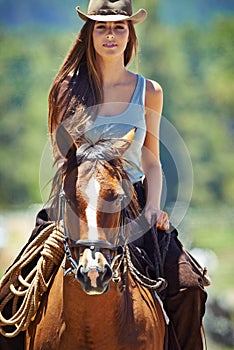 Loving the outdoors. Portrait of a gorgeous cowgirl with her horse.