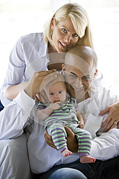 Loving parents with baby in dad's arms