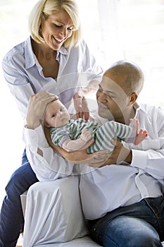 Loving parents with baby in dad's arms