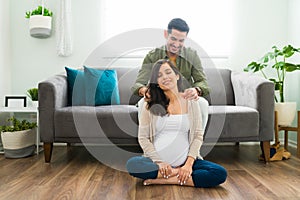 Loving partner massaging the back of an expectant mother