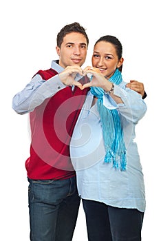 Loving pregnant couple forming heart