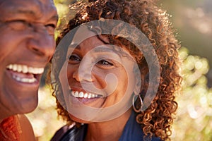 Loving Senior African American Couple Hiking Along Trail In Countryside Together