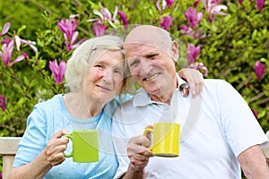 Loving senior couple drinking tea in the garden