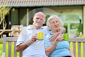 Loving senior couple drinking tea in the garden