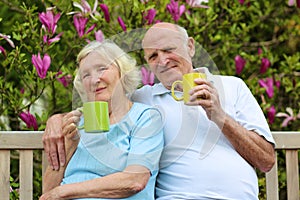 Loving senior couple drinking tea in the garden