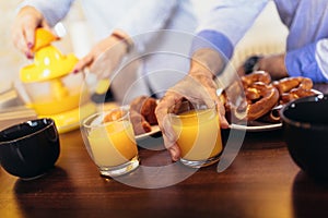 Loving senior couple having fun preparing healthy food on breakfast in the kitchen