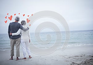 Loving senior couple standing on beach