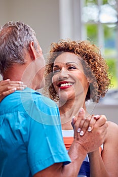 Loving Senior Couple On Summer Vacation Dancing Together In Holiday Apartment