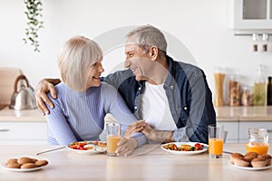 Loving senior husband and wife having breakfast together