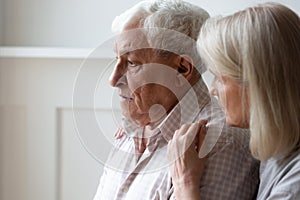 Loving senior wife hug comfort sad elderly husband