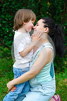 Loving son kissing his happy mother on the nose
