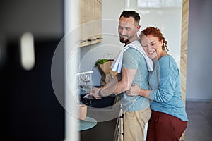 Loving spouces doing housework together stock photo