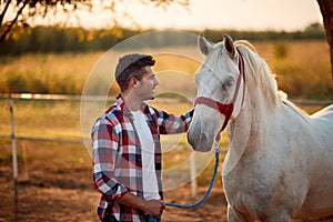 Loving tender moment between men and horse.Young man and horse