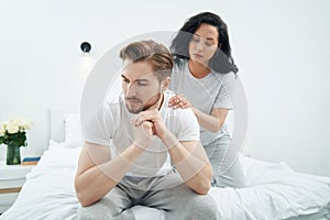 Loving woman giving her despondent partner soothing massage