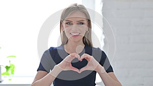 Loving Woman showing Heart Shape by Hands