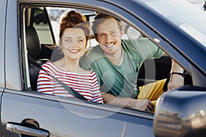 Loving young couple in car stock photo