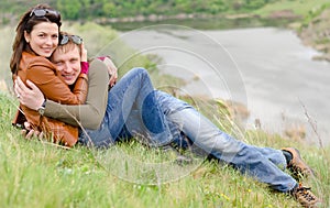Loving young couple embracing on a hill top