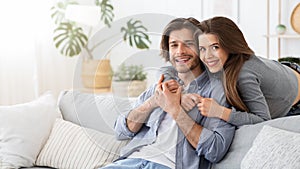 Loving young couple embracing at home, spending time together