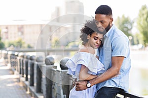 Loving young couple enjoying tender moment outdoors